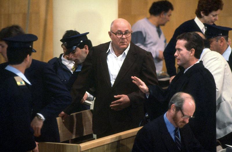 John Demjanjuk (C), 81-year-old retired auto worker living in Cleveland, OH, charged as a Nazi death camp guard, appears in a courtroom at the start of his trial February 16, 1987 in a Jerusalem.