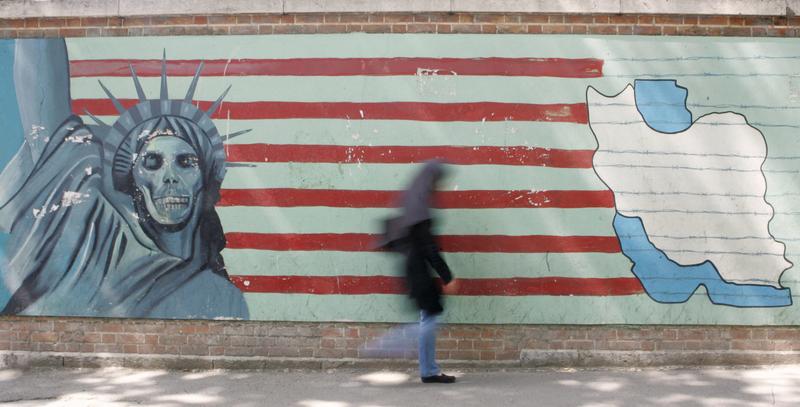 An woman passes by a mural on the wall of the former US embassy in Tehran. Militant students stormed the U.S. embassy on November 4, 1979, and held 52 Americans hostage for 444 days.