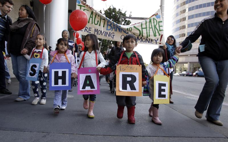 Occupy Wall Street demonstrators march to a Wells Fargo Bank as part of the protest in downtown Oakland, Calif., Friday, Nov. 4, 2011.