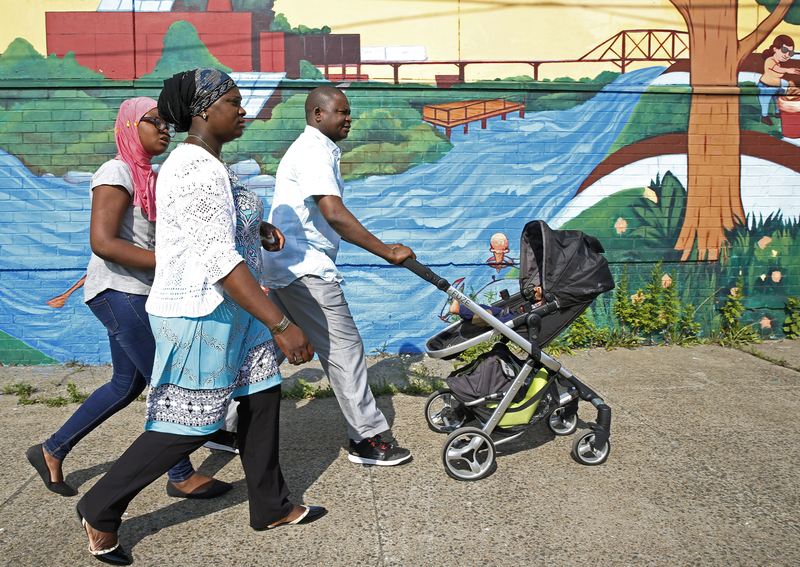 A family walks to a neighborhood park in the Bronx.