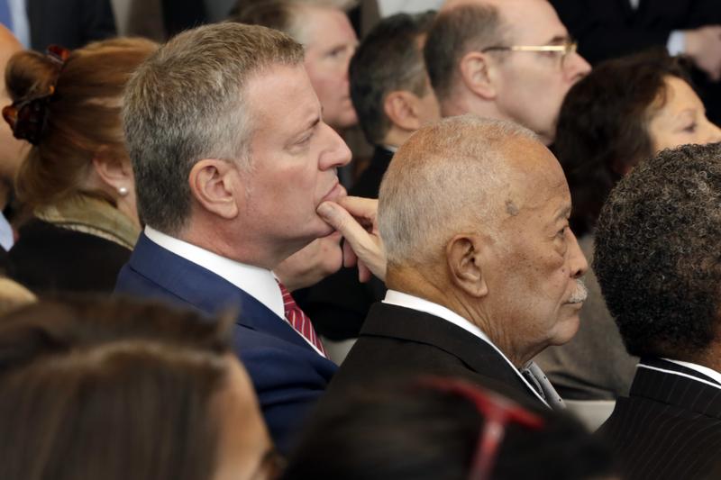 New York Mayor Bill de Blasio, left, and former Mayor David Dinkins listen as New York Gov. Andrew Cuomo delivers one of his State of the State addresses.