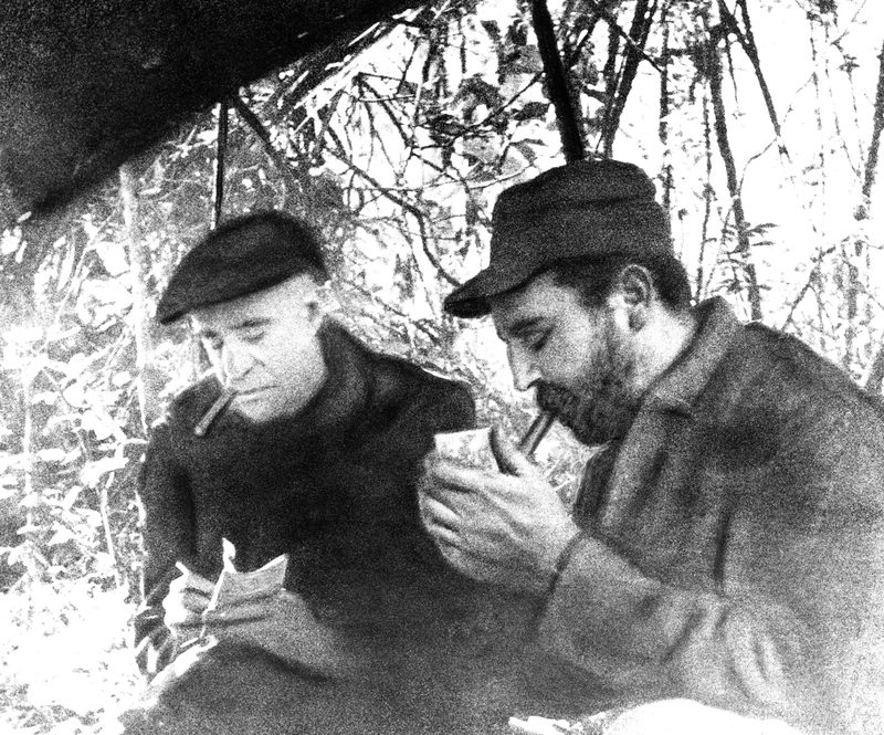 Fidel Castro, right, Cuban rebel leader, is interviewed in his hideout in the Sierra Maestra by Herbert l. Matthews of the New York Times, Feb. 17, 1957
