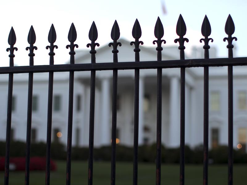 In this Sept. 23, 2014, file photo, the White House is seen through the North Lawn perimeter fence in Washington.