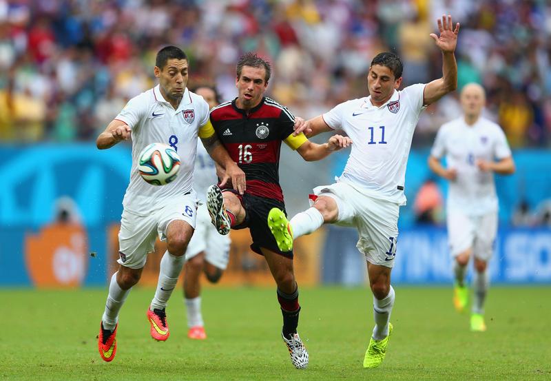 Philipp Lahm of Germany is challenged by Clint Dempsey (L) and Alejandro Bedoya of the U.S. during the 2014 FIFA World Cup Brazil group G match at Arena Pernambuco on June 26, 2014 in Recife, Brazil.