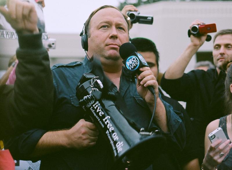 Alex Jones of InfoWars holds a megaphone at a protest in Dallas, Texas.