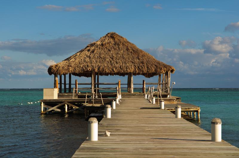 Beach deck with Palapa floating in the water on Ambergris Caye, Belize