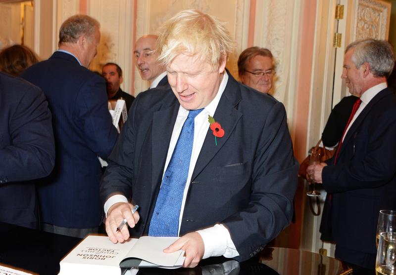 : Mayor of London Boris Johnson signs copies of his new book 'The Churchill Factor: How One Man Made History' at Dartmouth House on October 22, 2014 in London, England.