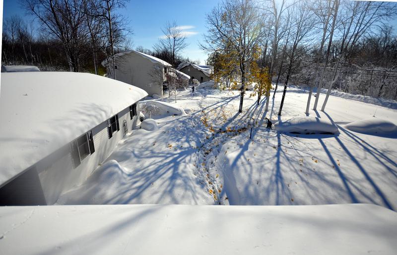 Drew Ahmed makes his way through nearly five feet of snow on November 19, 2014 in the Lakeview neighborhood of Buffalo, N.Y. The record setting Lake effect snowstorm dumped up to six feet of snow.