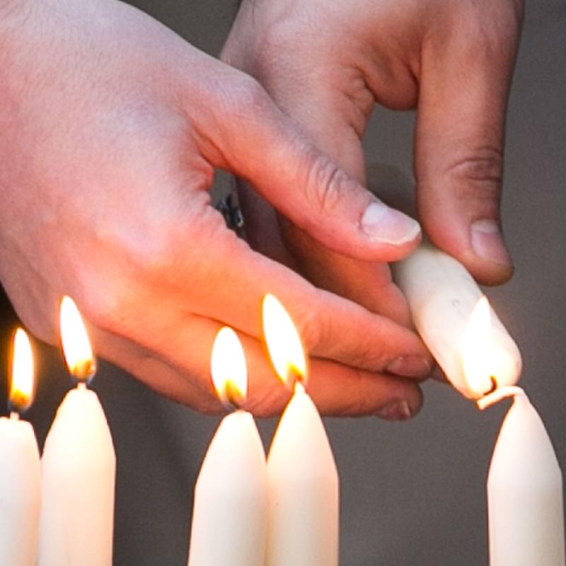 Candles are lit in honor of victims of an ISIS terrorist attack.