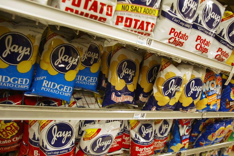 Bags of potato chips are seen on a grocery store shelf