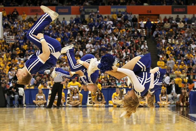 College cheerleaders perform stunts.
