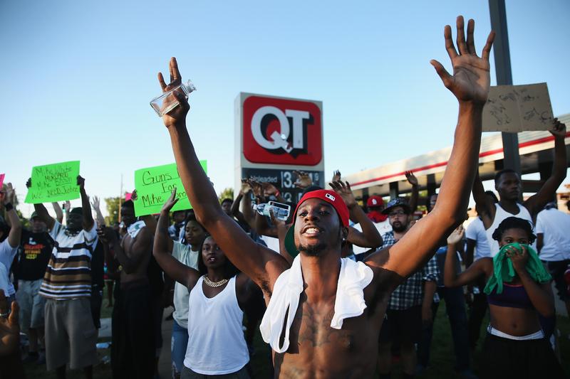 Demonstrators protest the killing of teenager Michael Brown on August 12, 2014 in Ferguson, Missouri.