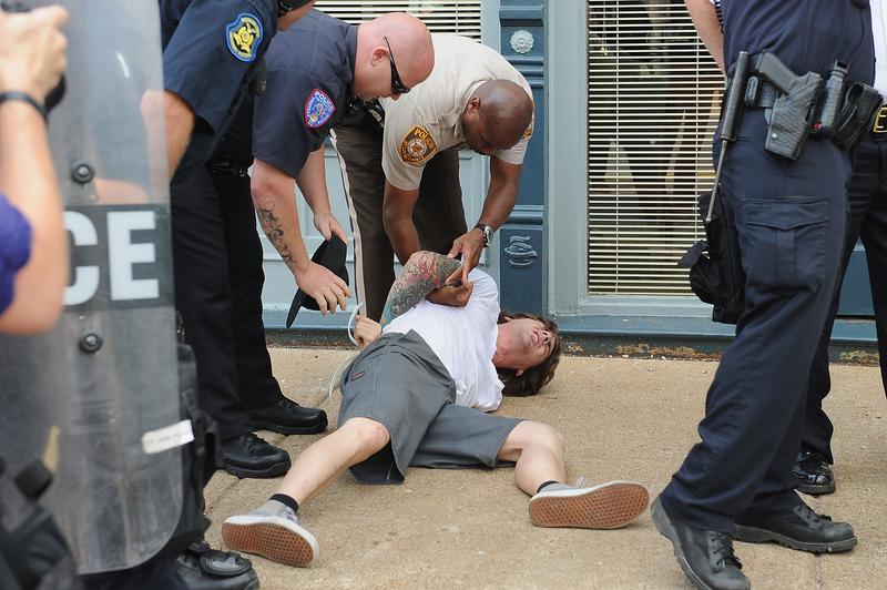 A man is arrested during a protest of the shooting death of 18-year-old Michael Brown outside Ferguson Police Department Headquarters August 11, 2014 in Ferguson, Missouri.