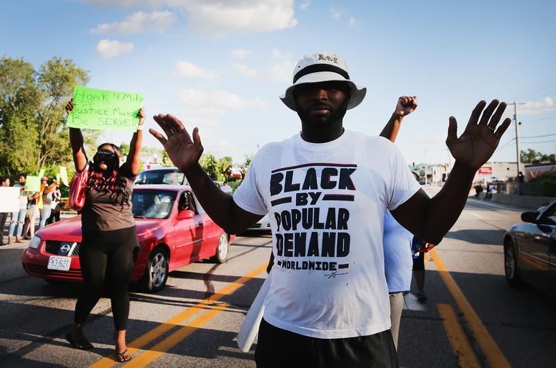 Demonstrators protest the killing of teenager Michael Brown on August 12, 2014 in Ferguson, Missouri.