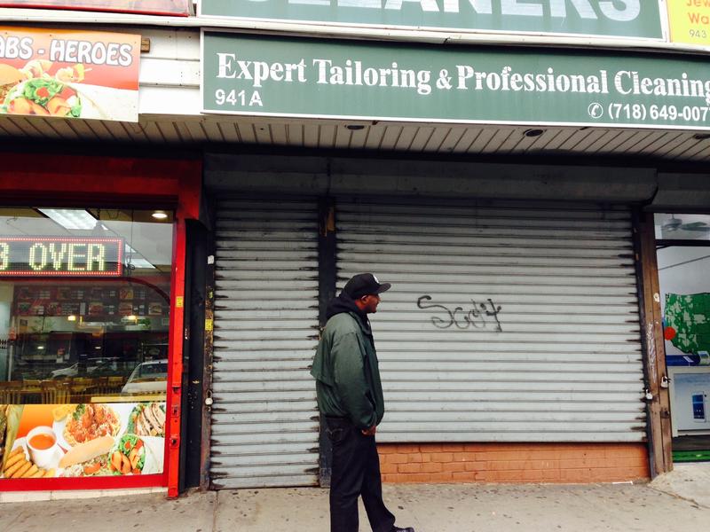 Outreach worker Rob walks along a strip of shops in East New York. He considers the area a hot spot for violence.