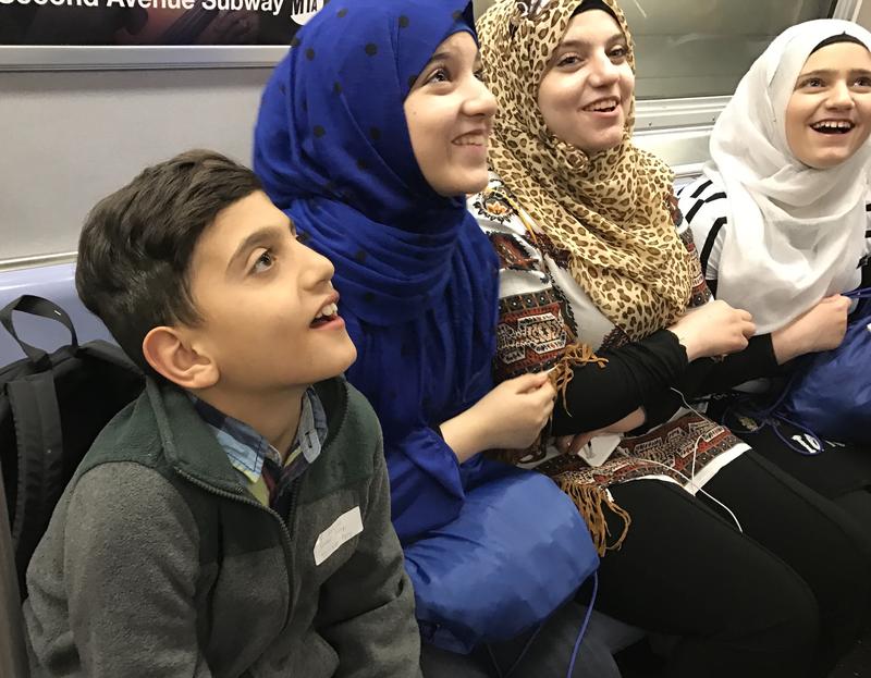 Syrian refugees on their first subway ride in New York City.