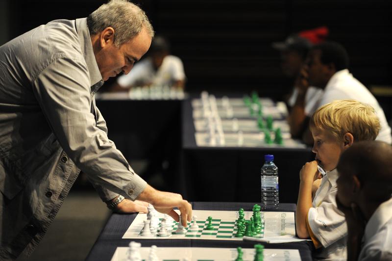 Former World Chess Champion Garry Kasparov plays a game of chess against eight-year old Ronan Ferreira on March 25, 2012in Pretoria, South Africa.