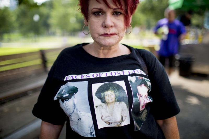 Kimberly Krawczyk wears a t-shirt of the people she has lost to drugs, including her mother, father and brother, during a rally in Boston Common on National Overdose Awareness Day.