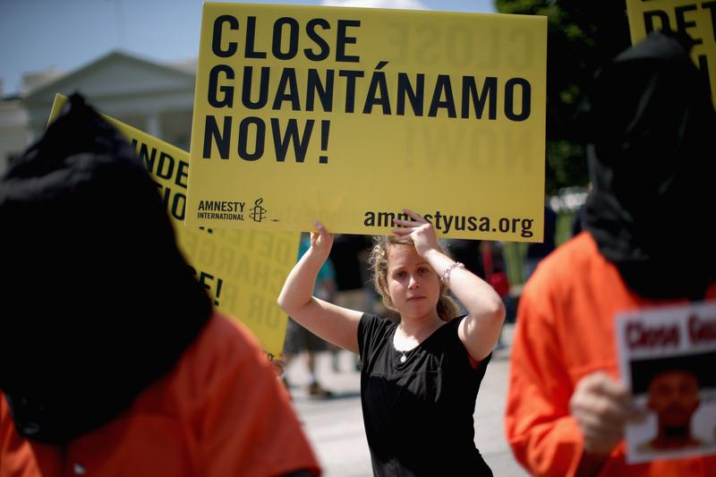 Demonstrators hold a rally to urge President Barack Obama to fulfill his pledge to close the military prison at Guantanamo Bay, Cuba, and end indefinite detention outside the White House May 23, 2014.