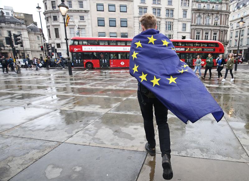 A demonstrator wrapped in a European flag leaves an anti-Brexit protest in Trafalgar Square in central London on June 28, 2016.