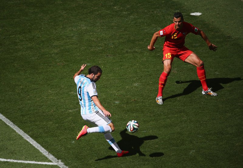 Gonzalo Higuain of Argentina scores against Daniel Van Buyten of Belgium during the 2014 FIFA World Cup Brazil Quarter Final match between at Estadio Nacional on July 5, 2014 in Brasilia, Brazil.