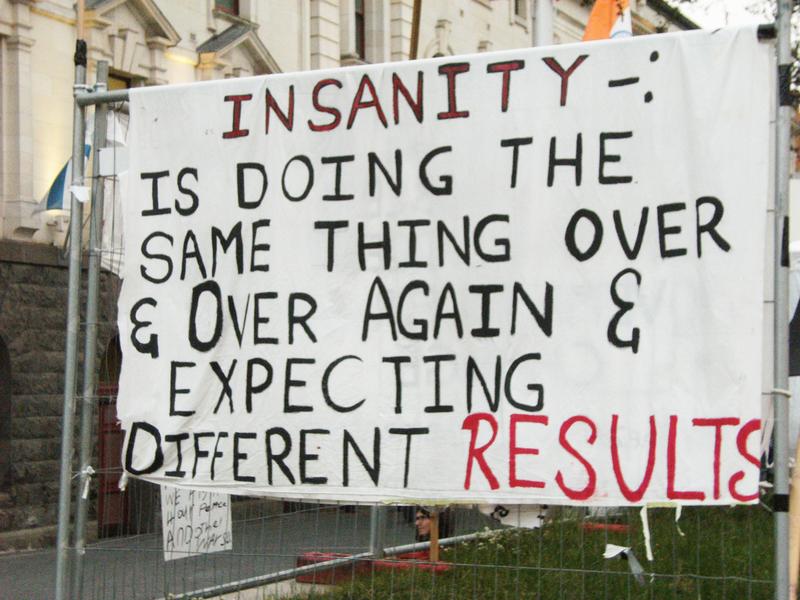 A protest sign that was hanging on a fence at the Occupy Auckland Protest camp. 2011