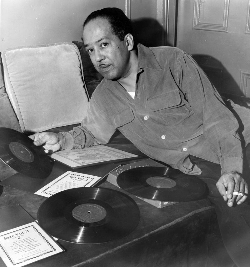 American author Langston Hughes in 1954 with a phonograph record in hand.