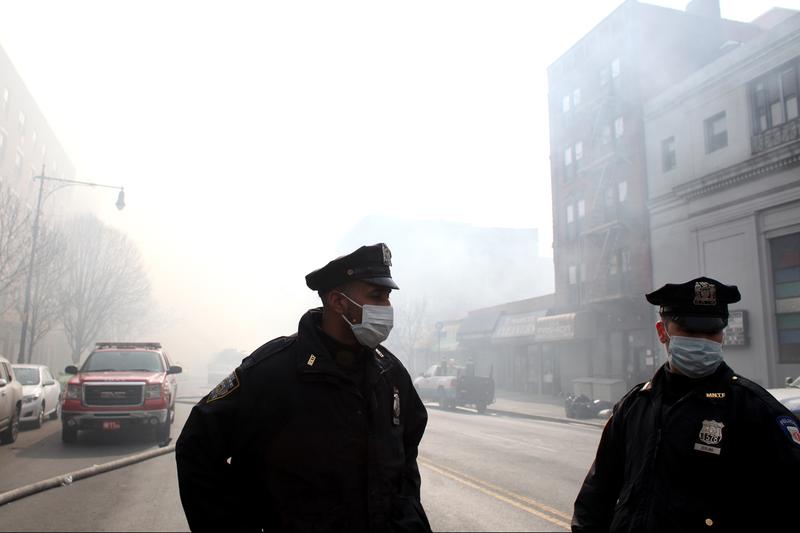 NYPD and hundreds of firefighters responded to a 5-alarm fire at the site of two building explosions in East Harlem on March 12, 2014.