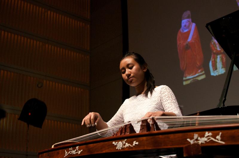 Guzheng player Rujia Teng performs 'The Eternal Sorrow of Lin'An' by Zhanhao He with projected artwork.