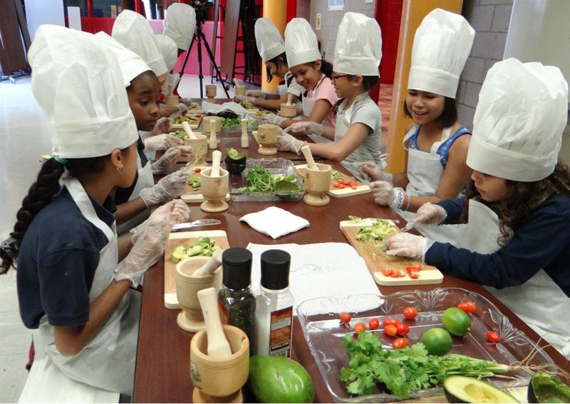 Kids making guacamole in a Coqui the Chef program in the South Bronx