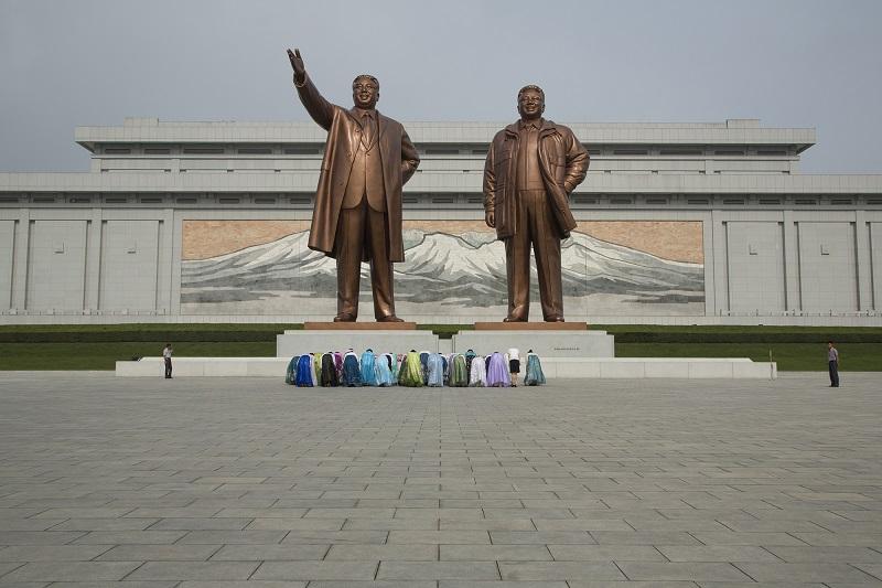 The cult of Kim. Local ladies pay respect to Kim Ill-sung and Kim Jung-il, their "Dear Great Leaders" at the Mansudae Grant Monument, the apogee of great leader love. In Pyongyang.