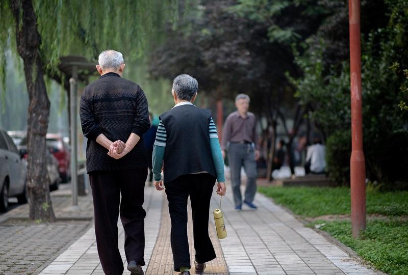 An old couple walk on the street. In China, there are more than 200 million old people of over 60 years old at present, which accounts for 15% of total population.