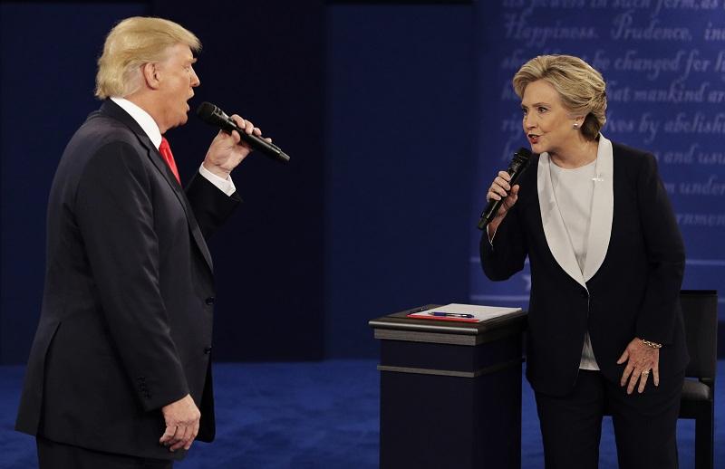 In this Sunday, Oct. 9, 2016, file photo, Republican presidential nominee Donald Trump and Democratic presidential nominee Hillary Clinton speak during the second presidential debate in St. Louis.