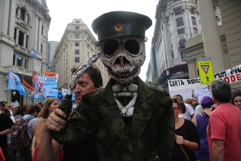 In Buenos Aires, a costumed demonstrator marks the anniversary of Argentina's 1976 military coup.