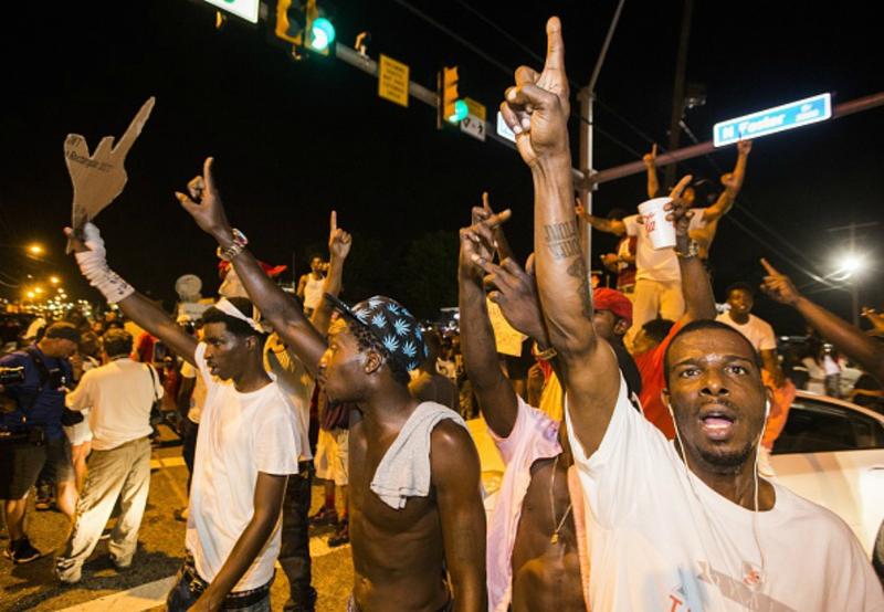 Protesters block traffic and dance on cars near theTriple S Food Mart where Alton Sterling was shot and killed, July 6, 2016 in Baton Rouge, Louisiana