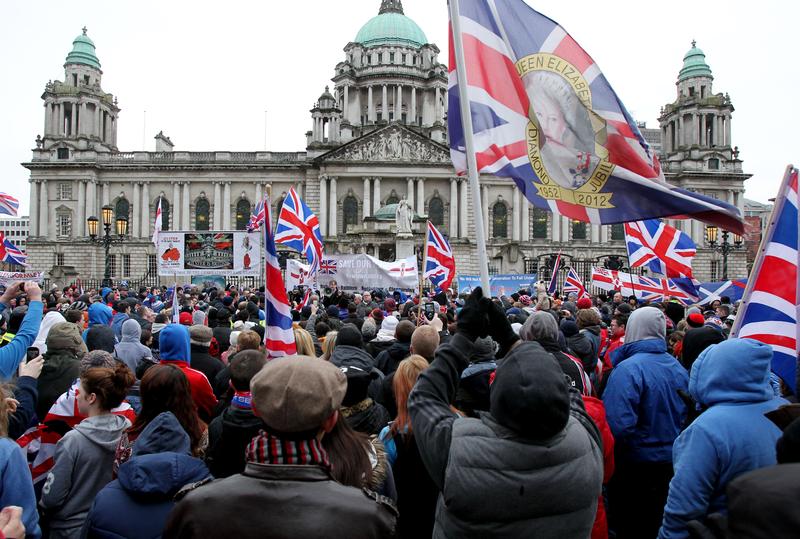 Loyalist protesters hold Union Flags during a demonstration outside Belfast City Hall in Belfast, Northern Ireland on January 19, 2013