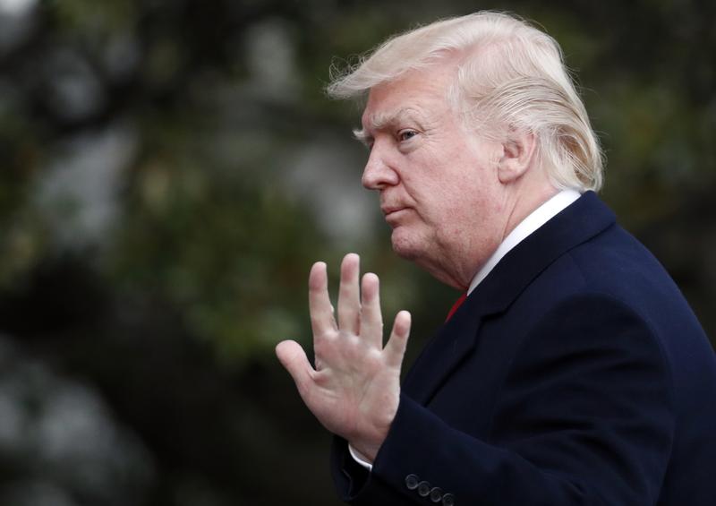 President Donald Trump waves as he walks to the White House after arriving on Marine One, Sunday, March 19, 2017, in Washington. Trump is returning from a trip to his Mar-a-Lago estate in Palm Beach,