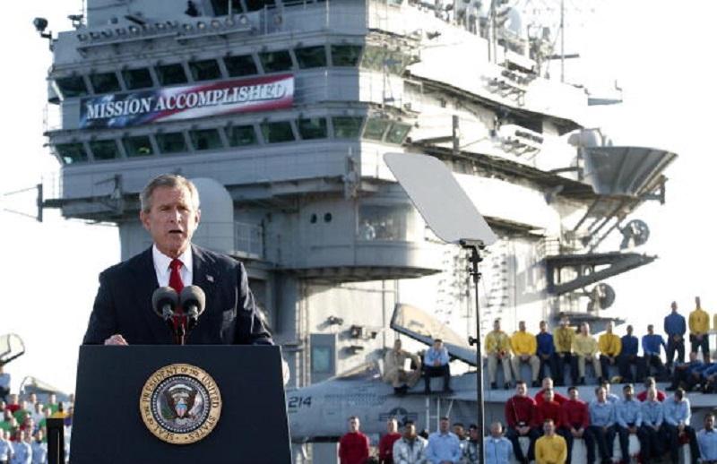 US President George W. Bush addresses the nation aboard the nuclear aircraft carrier USS Abraham Lincoln 01 May, 2003, as it sails for Naval Air Station North Island, San Diego, California.