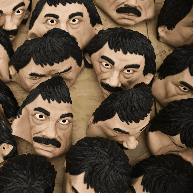 Masks of Mexican drug trafficker Joaquin Guzman Loera, aka 'El Chapo', are pictured in a factory of costumes and masks