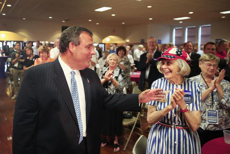 New Jersey Gov. Chris Christie (L) greets Carolyn Scott after delivering a speech at the 'An Evening at the Fair' event with Scott County Republicans in Iowa.