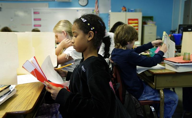 In this photo taken April 18, 2014, students in a fourth-grade classroom at Olympic View Elementary School in Lacey, Wash. use upright file folders to shield their papers during an exam.