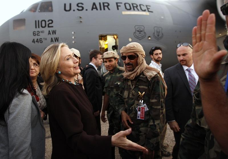 U.S. Secretary of State Hillary Clinton bids farewell to Libyan officials and fighters loyal to the National Transitional Council upon her departure from a one day visit to Tripoli on Oct 18, 2011.