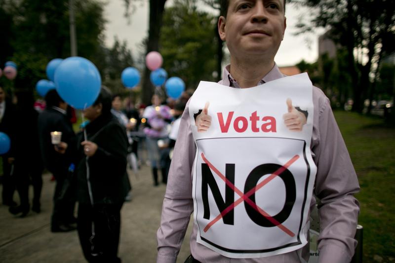 A man with a sign reading "Vote No" attends a rally organized by supporters of the "no" vote for the referendum on the Colombian peace deal.