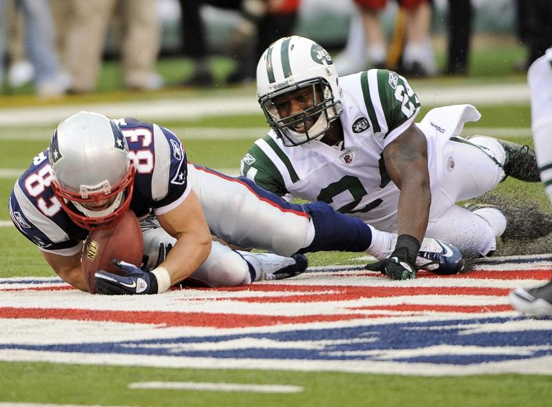 New York Jets cornerback Darrelle Revis (24) tackles New England Patriots wide receiver Wes Welker (83) during the second quarter of an NFL football game at New Meadowlands Stadium in East Rutherford,