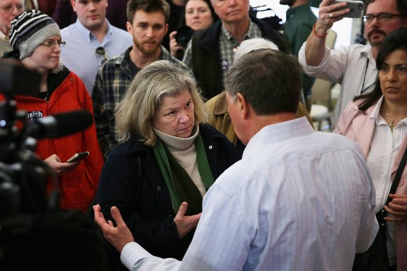 GOP presidential candidate Ohio Gov. John Kasich talks to voters -- some of them undecided about who they will vote for -- at the end of a town hall meeting at the Portsmouth Country Club 2/1/16.