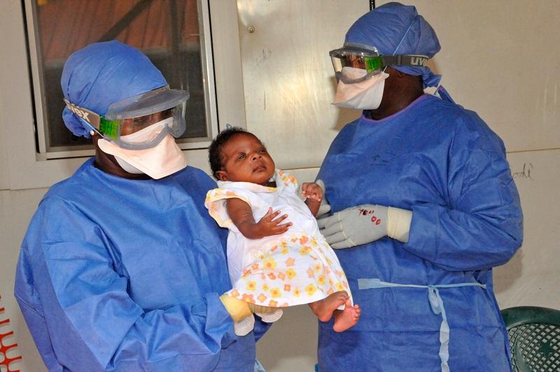 Medical workers present Noubia (C), the last known patient to contract Ebola in Guinea, during her release from a Doctors Without Borders treatment center in Conakry on November 28, 2015.