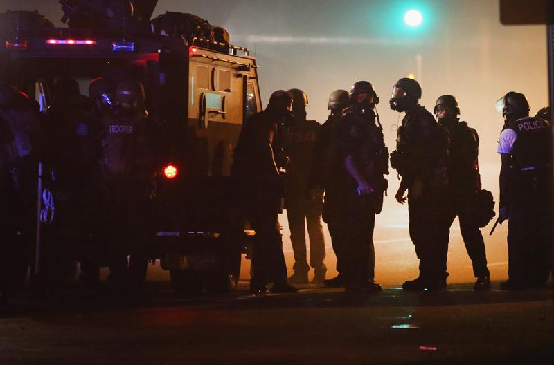 Police attempt to control demonstrators protesting the killing of teenager Michael Brown on August 18, 2014 in Ferguson, Missouri. Police shot smoke and tear gas to disperse the protestors with as th