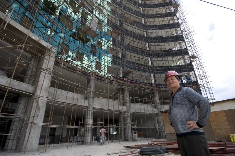 Chinese constructor Liou stands next to a site in Nairobi on May 13, 2014. Kenyan contractors are losing out to Chinese firms that are grabbing lucrative construction tenders for private projects.