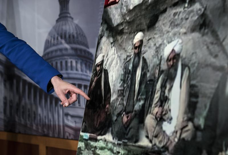 US Senator Kelly Ayotte points to a photo of Sulaiman Abu Ghaith (L) during a press conference on Capitol Hill on March 7, 2013 in Washington, DC.