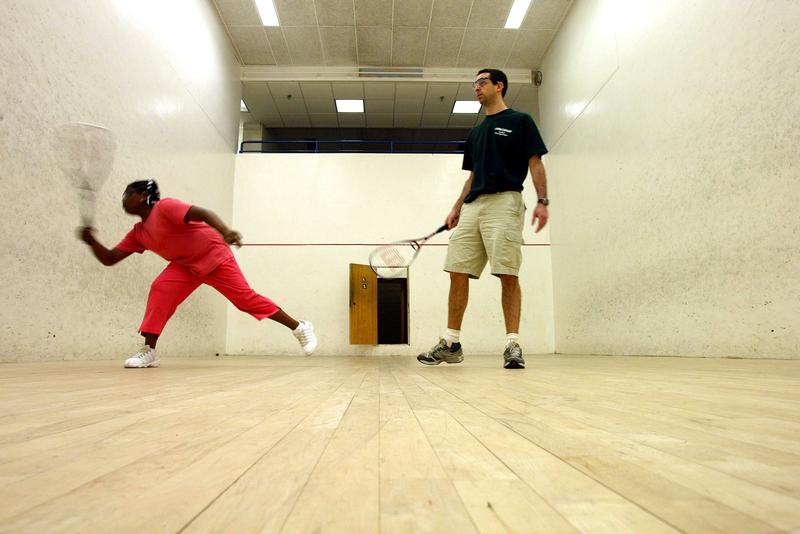 Squash instructor and StreetSquash founder George Polsky plays squash with a student during a summer StreetSquash education session July 9, 2003